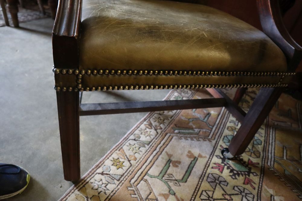 A George III style mahogany library chair, upholstered in buttoned green leather, width 58cm height 100cm